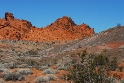 Scenic view of rocky mountains against clear blue sky