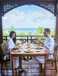 Rear view of woman sitting at restaurant