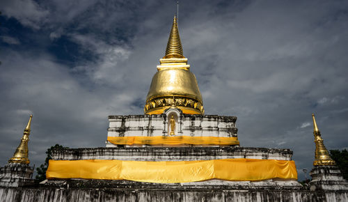 Temple by building against sky