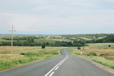 Country road passing through field