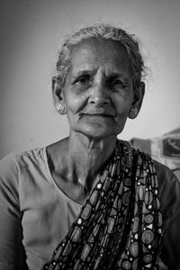 Portrait of mid adult woman against blurred background