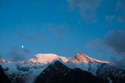 Scenic view of snow covered mountains against sky