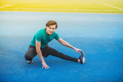 Young man exercising at stadium