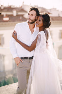 Portrait of young couple standing outdoors