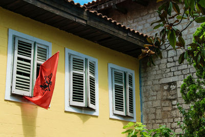 Low angle view of flag against building