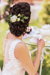 Midsection of woman holding flower bouquet