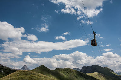 Low angle view of overhead cable car against sky