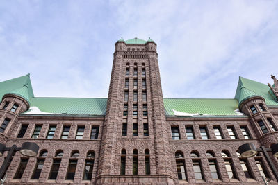 Low angle view of building against cloudy sky