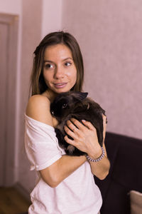 Portrait of young woman with dog