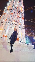 Full length of woman standing in snow