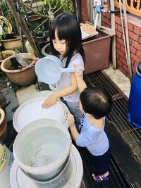 High angle view of siblings in container