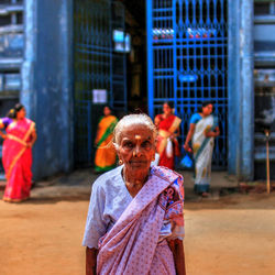 Woman standing on footpath