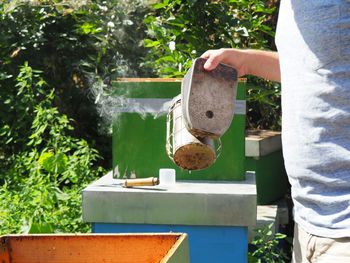 Midsection of man holding plant