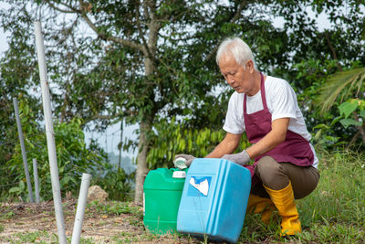 Man holding containers on land