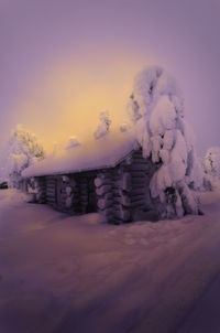 Snow covered landscape against sky