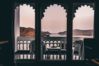 Buildings seen through window during sunset