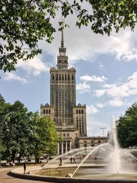 Palace of culture and science against cloudy sky