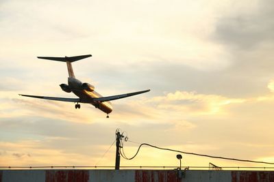 Low angle view of airplane flying in sky