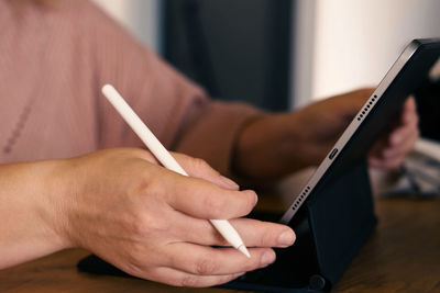 Midsection of woman using mobile phone