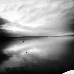 Scenic view of lake against cloudy sky