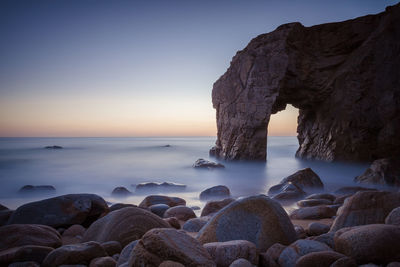 Scenic view of sea against clear sky at sunset