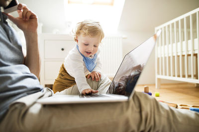 Father with his little son working from home