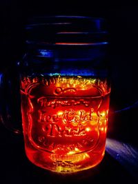 Close-up of illuminated glass on table