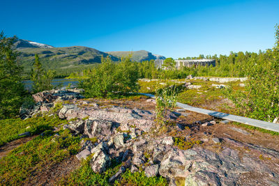 Scenic view of mountains against clear blue sky