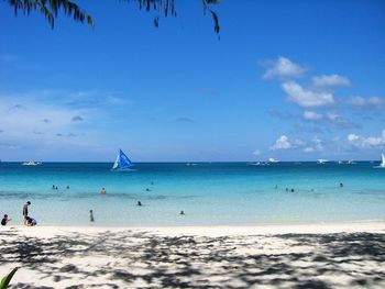 Scenic view of beach against clear blue sky