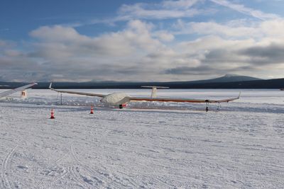 Scenic view of beach against sky during winter