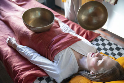 High angle view of woman lying on table at home