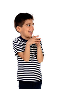 Smiling boy standing against white background