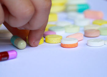 Close-up of hand holding multi colored pencils