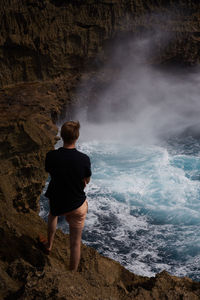 Rear view of man looking at sea