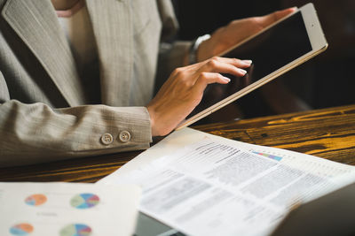 Midsection of businessman using laptop