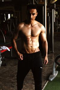 Muscular man standing at gym