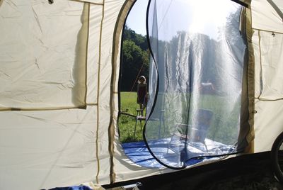 Close-up of tent seen through window