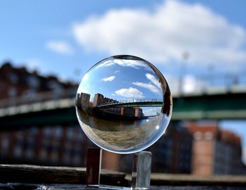 Reflection of building in river against sky