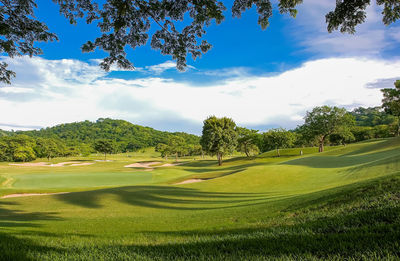 Panoramic view of golf course against sky