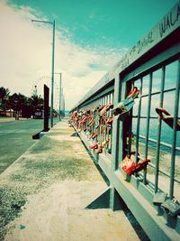 Graffiti on building by street against sky