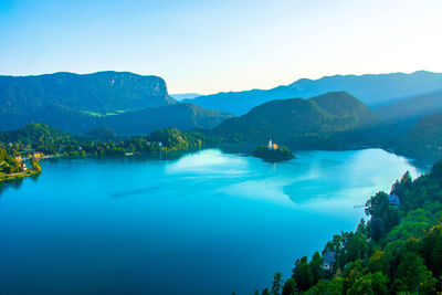 Scenic view of sea and mountains against sky