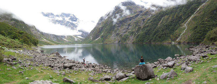 Scenic view of river with mountains in background