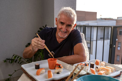 Portrait of senior man preparing food at home