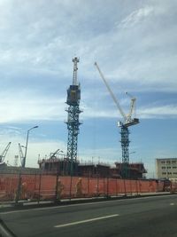 Construction site against cloudy sky