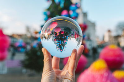 Close-up of hand holding crystal ball