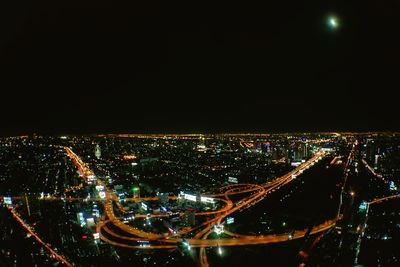 High angle view of illuminated cityscape against sky at night