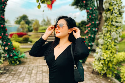 A woman is posing in the park