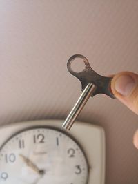 Close-up of hand holding clock