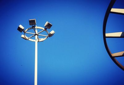 Low angle view of street light against clear blue sky