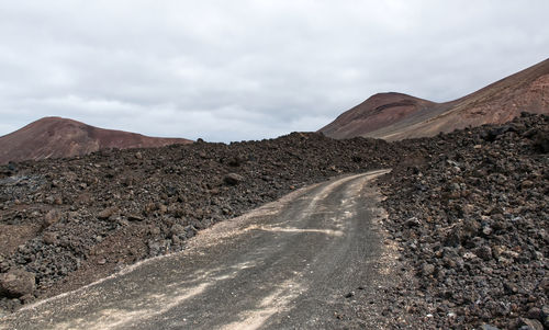 A road built between the solidified lava of a volcano. lanzarote. canary islands, spain